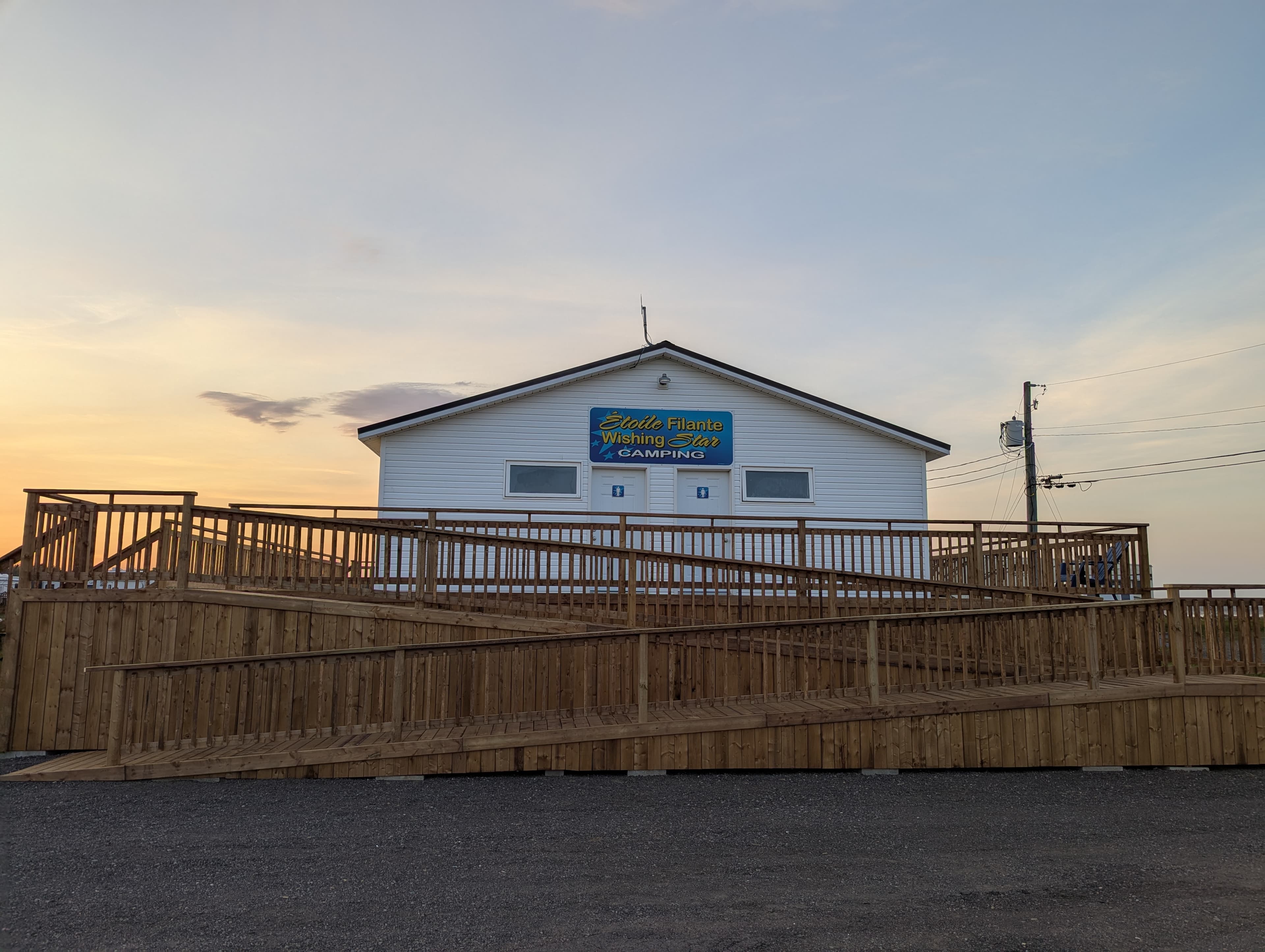 Wheelchair-accessible ramp leading up to the main facility building at Wishing Star Camping